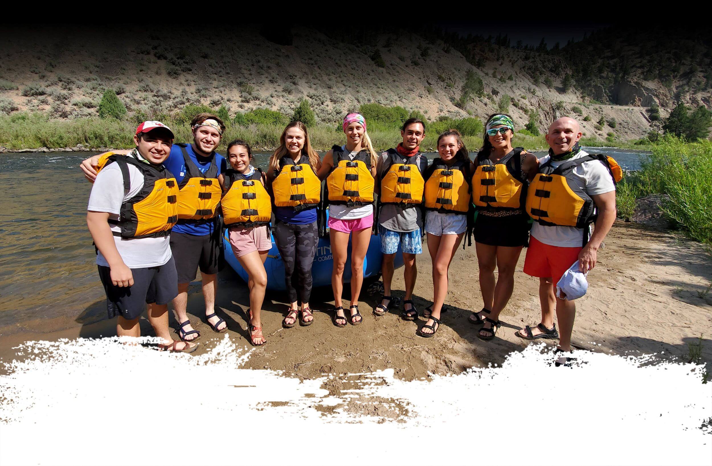 Guided group rafting trip in Colorado, showing a team of paddlers having successfully navigated waves and rapids as part of a large party adventure with the Colorado Rafting Company.