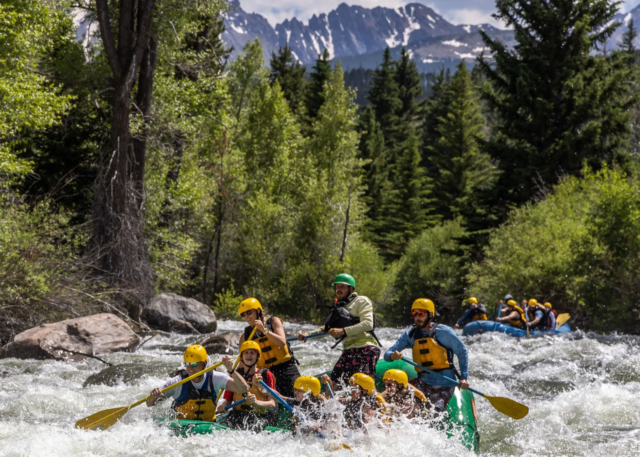 Rafters navigate wild whitewater rapids on Blue River rafting trip
