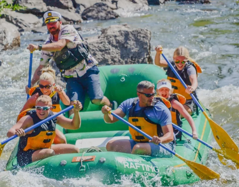 Rafters charging through splash-filled rapids near Grand Lake Colorado on a thrilling river run