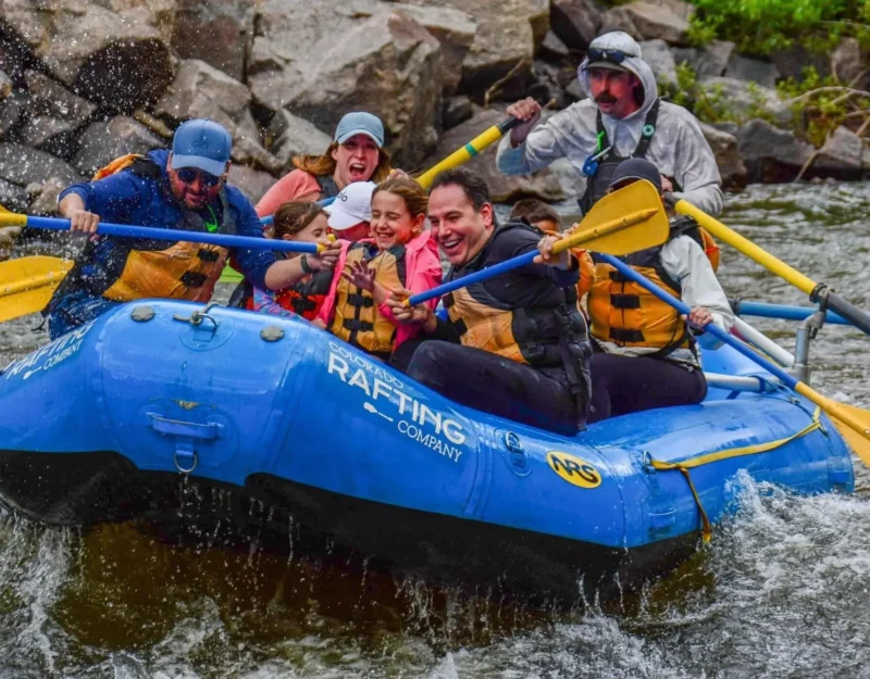 Group enjoying white water rafting trips in Vail Colorado navigating fun rapids